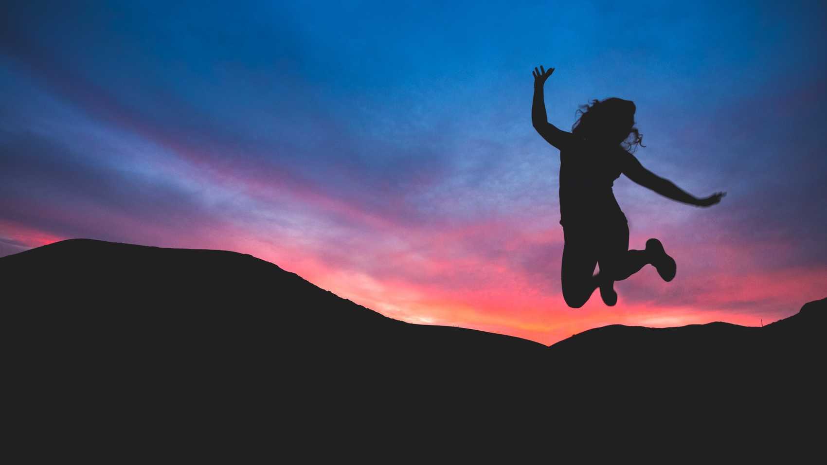 Jumping for joy at sunset